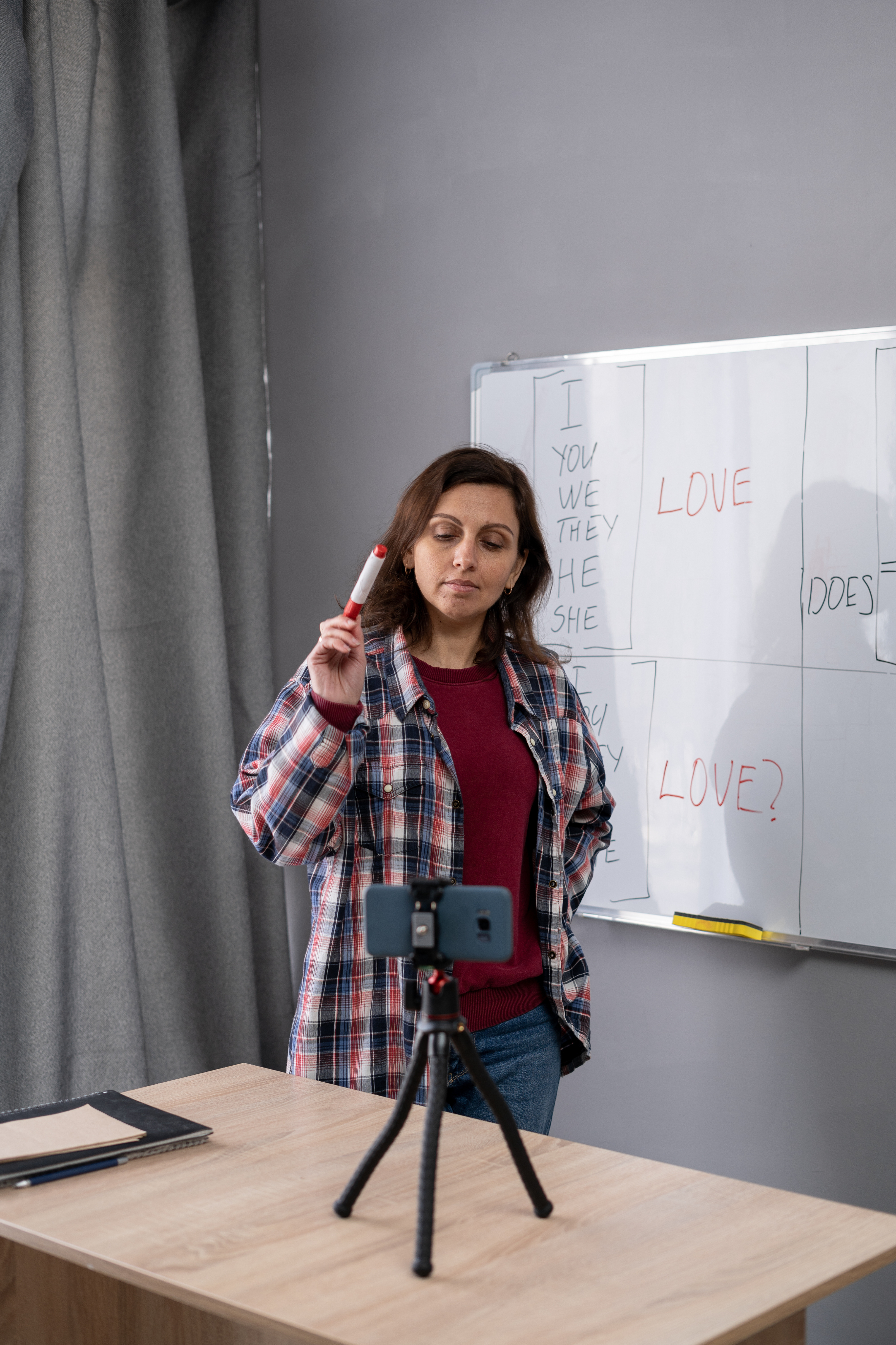 Shows a trainer working with two volleyball players on blocking at the next